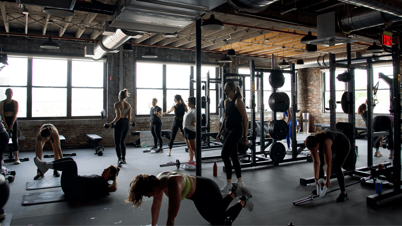 Strength training area at B/SPOKE South Boston’s new third floor featuring squat racks and sleds