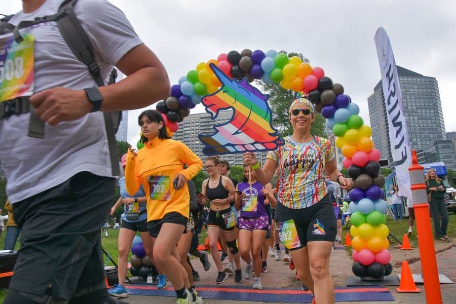 Participants celebrating Pride Month at a community fitness event in Boston, featuring inclusive workouts, movement, and LGBTQIA+ community connection.