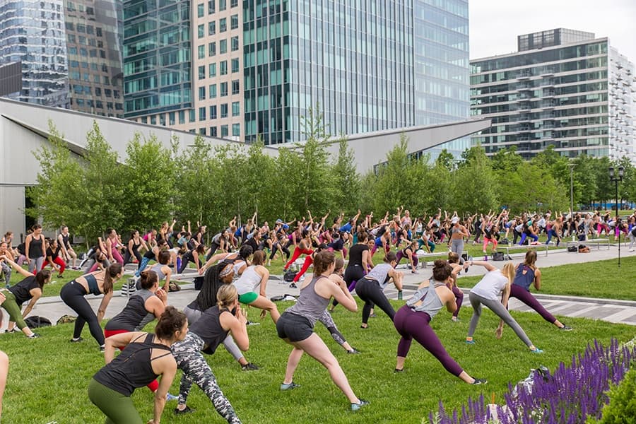 Group participating in a free outdoor Labor Day fitness class in Boston
